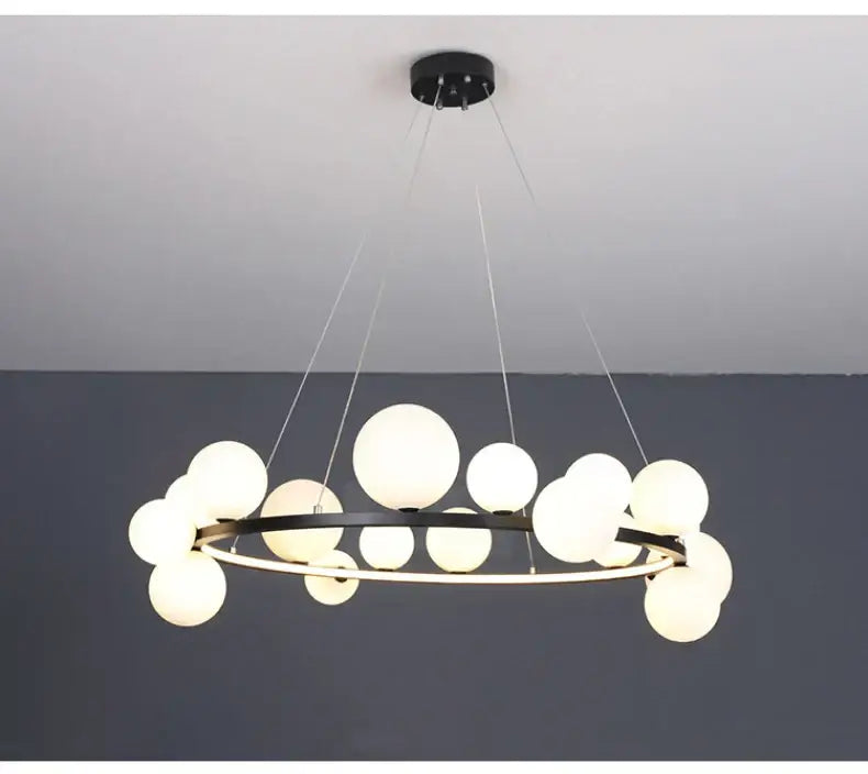 Modern black metal chandelier with multiple frosted glass globe lights and adjustable cord for versatile installation