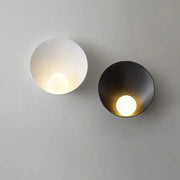 Two minimalist decorbites™ modern led wall lights in matte white and brushed black with circular recessed light sources
