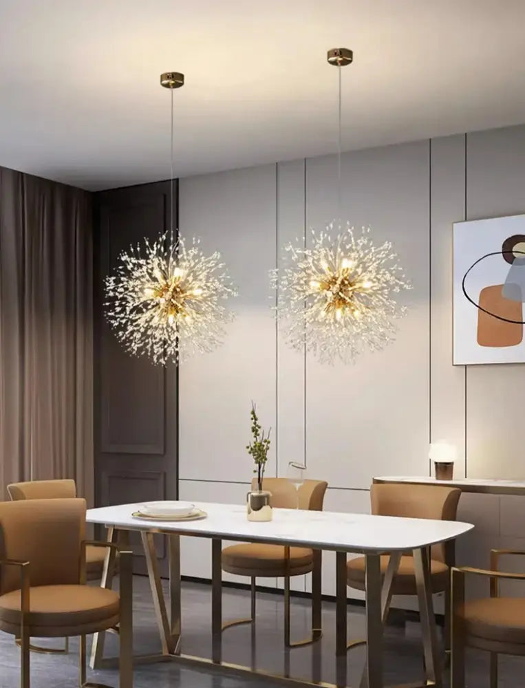 Two elegant gold-toned decorbites modern led pendant chandeliers with starburst crystals for home decor lighting above table