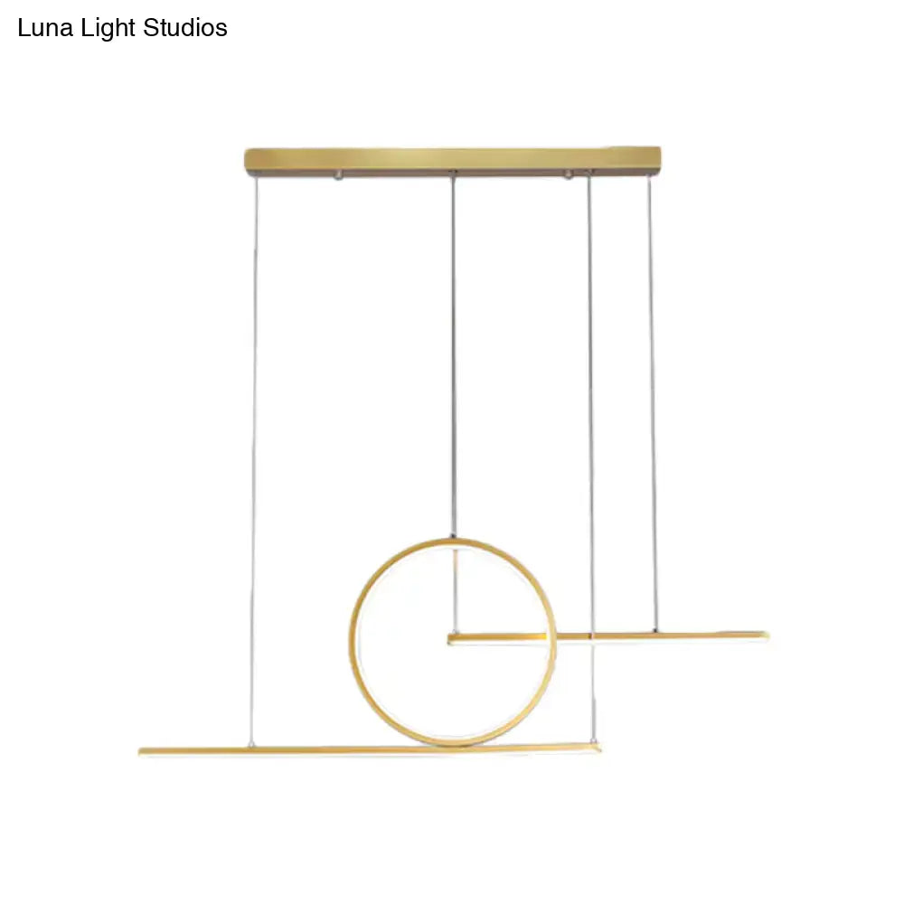 Modern gold-toned geometric pendant ceiling light with circle and linear metal shade emitting warm white light