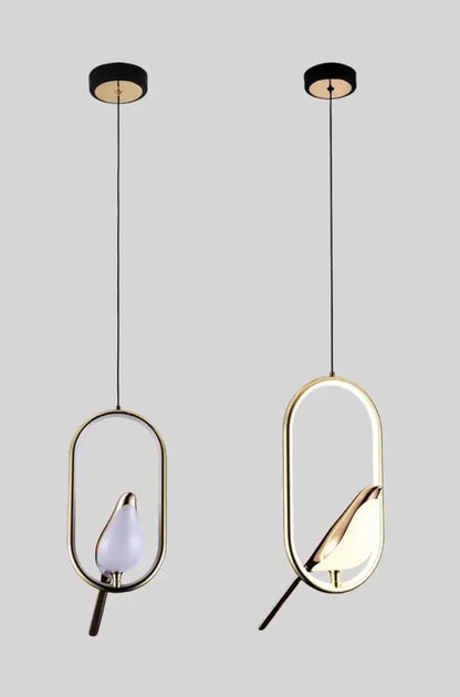 Two gold-toned decorbites™ modern magpie bird led pendant lights with oval frames and illuminated bird-shaped bulbs