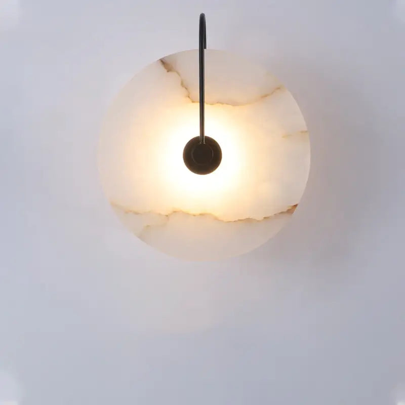 DecorBites™ modern marble wall lamp featuring a circular warm-toned onyx shade with a sleek black metal arm