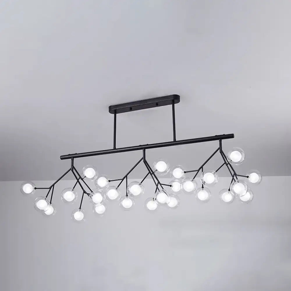 Black metal linear island chandelier with clear glass globe bulbs in a branching LED pendant fixture design