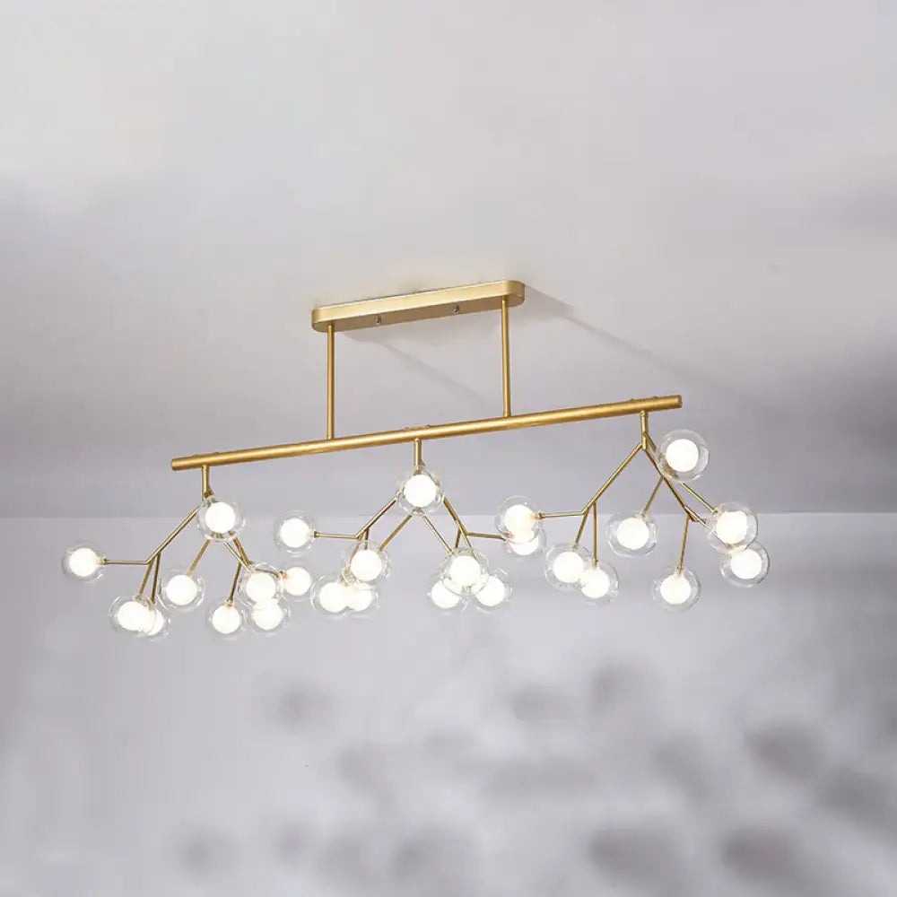 Gold-toned DecorBites modern metal linear island light with branching design and clear glass globe bulbs