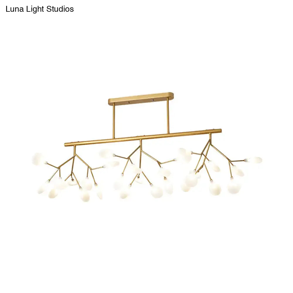 Gold-toned modern metal linear island chandelier with branching arms and frosted glass globe bulbs by DecorBites