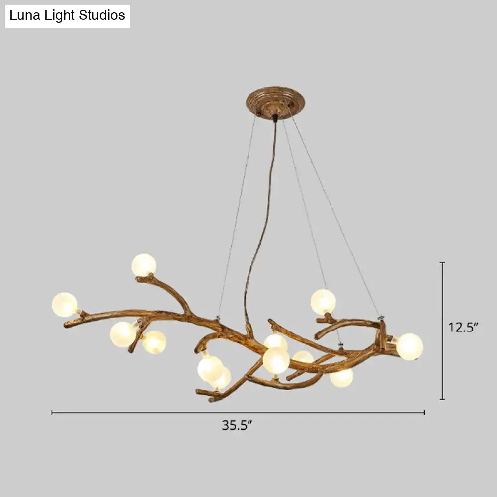 Bronze-finished metal tree branch chandelier with frosted glass globes and art deco wood suspension for island lighting