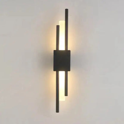 Modern metal wall lamp by decorbites featuring three vertical black rods and a central square base emitting warm light