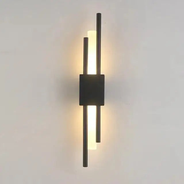 Modern metal wall lamp by decorbites featuring three vertical black rods and a central square base emitting warm light