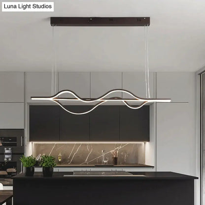 Modern minimalist pendant light in brushed black metal with glowing led strip and adjustable chain cord length for dining room