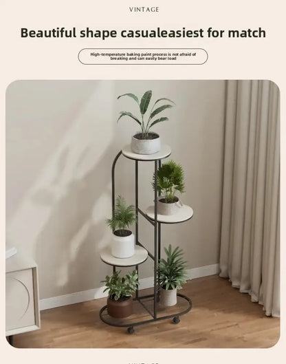 Black metal plant stand with five circular shelves holding potted green plants in ceramic pots for interior decor