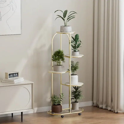 Gold-finished metal plant stand with five tiered shelves and caster wheels for modern interior decor flower rack