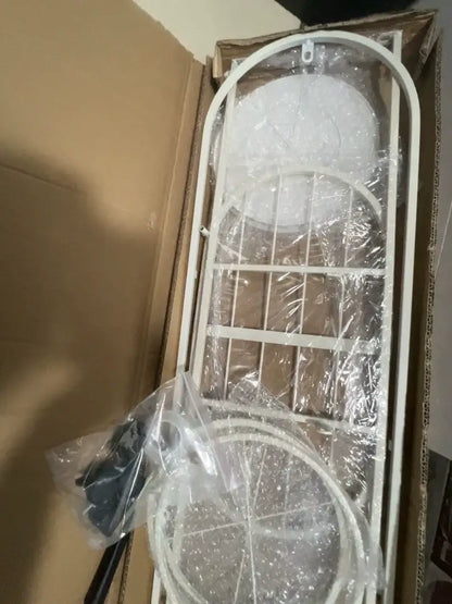 White metal garden arbor with curved top lattice design as DecorBites modern multi-storey plant stand for interior decor