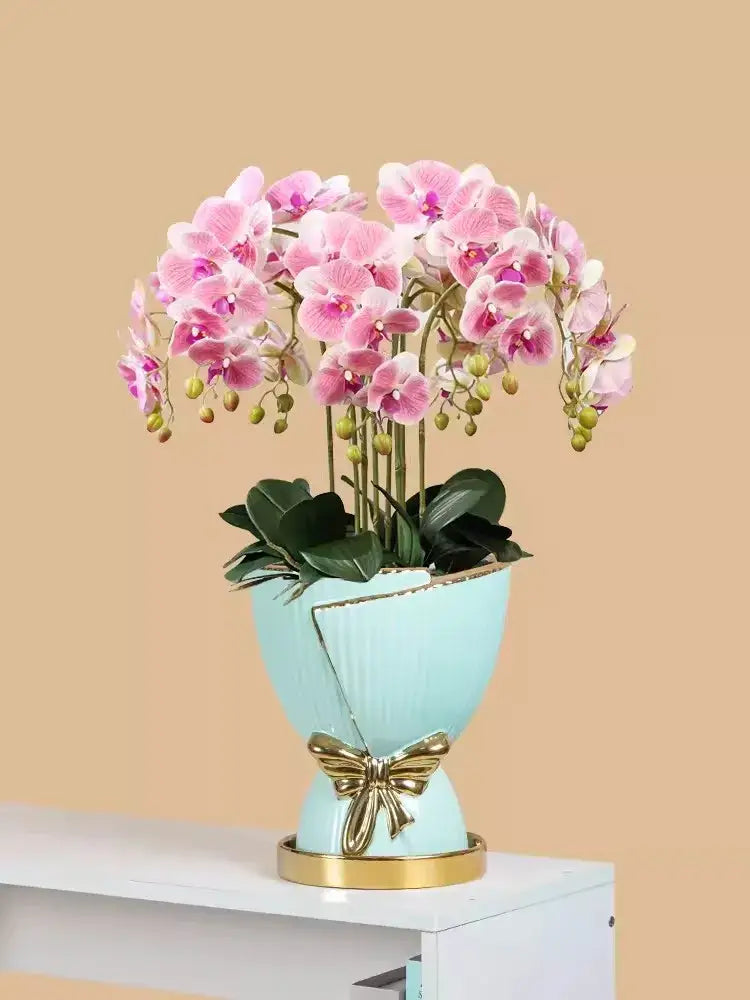 DecorBites™ modern nordic ceramic vase in light blue with gold accents holding pink orchids for elegant home decor