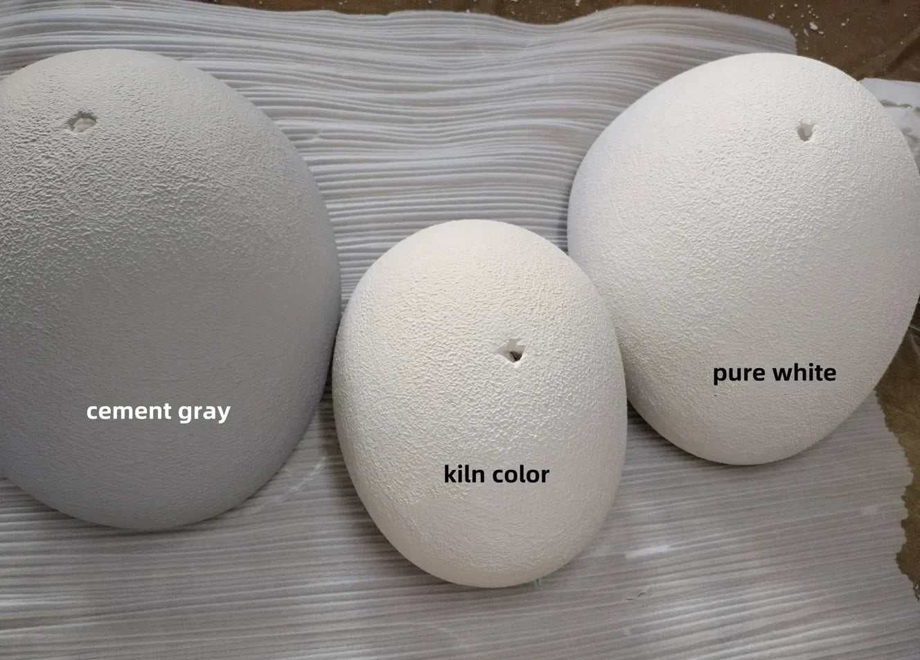 Three ceramic egg-shaped lamps in cement gray kiln color and pure white for warm light modern nordic chandelier use