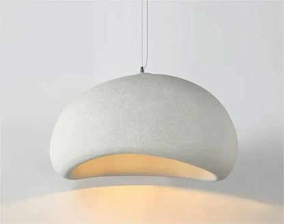 A soft off-white textured dome pendant light with warm light turn in the modern nordic chandelier DecorBites™ for dining