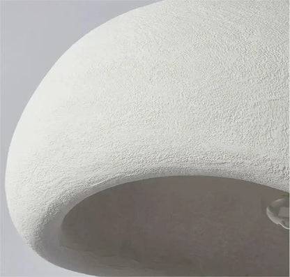A smooth white dome-shaped decorbites modern nordic chandelier textured surface providing warm light for home and dining