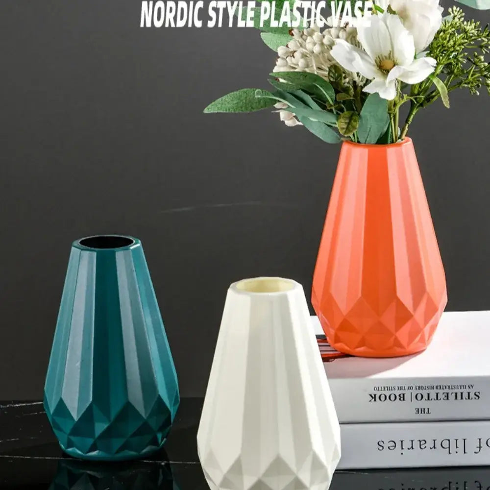 Orange geometric plastic flower vase with a faceted diamond shaped design from DecorBites™ Modern Nordic collection