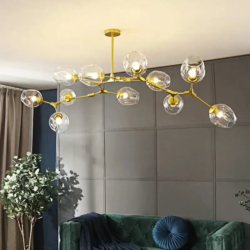 Gold-toned decorbites modern nordic glass chandelier with multiple clear glass globe shades for elegant lighting