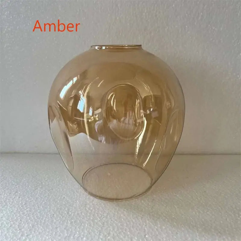 Amber-colored glass lampshade with smooth rounded dome and subtle ridges in DecorBites modern nordic glass chandelier