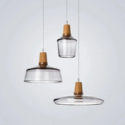 Set of three DecorBites modern nordic glass light fixtures with clear glass shades and warm wooden accents