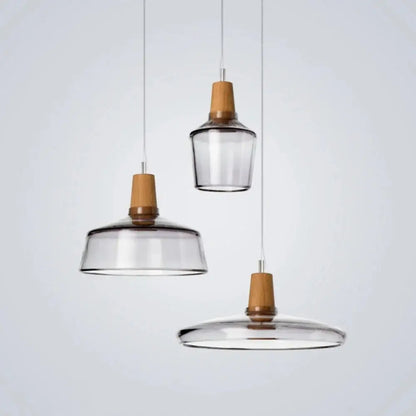 Set of three DecorBites modern nordic glass light fixtures with clear glass shades and warm wooden accents