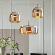 DecorBites™ modern nordic glass pendant lamp with amber-tinted glass and brass accents for contemporary kitchens