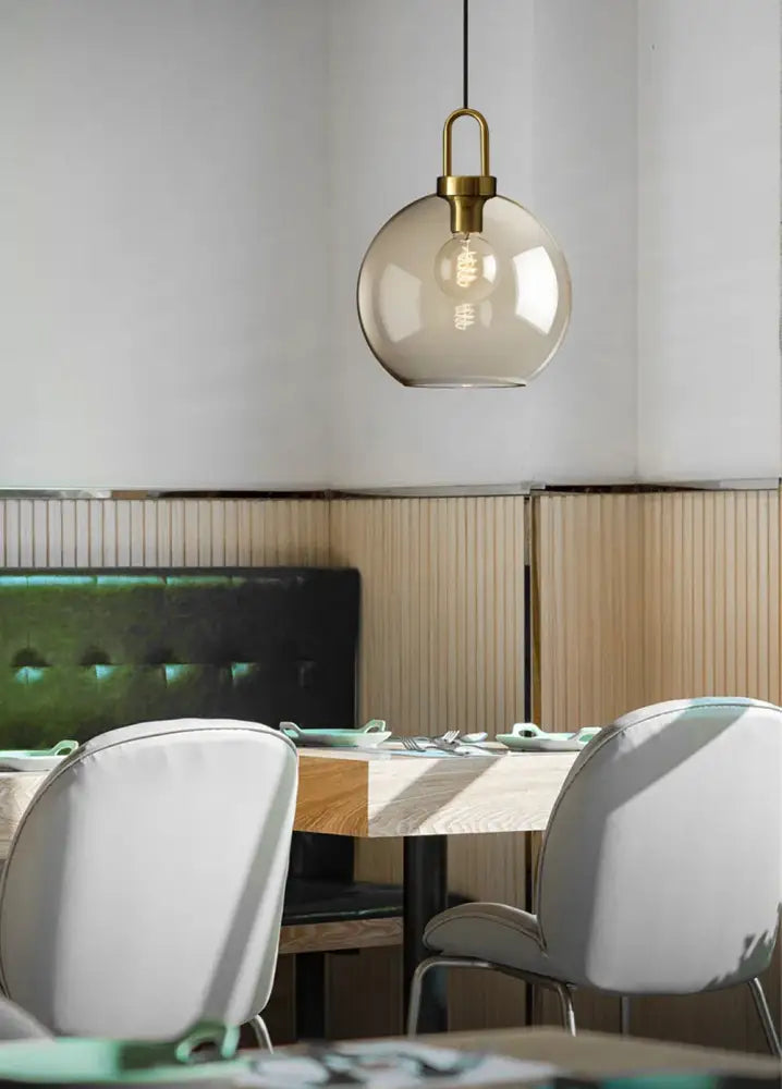DecorBites modern nordic glass pendant light with smoked glass globe and brass hardware for kitchen and restaurant use