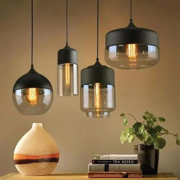 Set of four DecorBites™ modern nordic pendant lighting with black metal shades and clear glass globes housing filament bulbs
