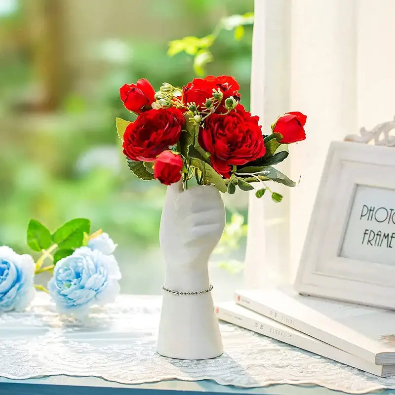 Decorbites™ modern nordic style white ceramic hand vase with silver bracelet detail holding vibrant red artificial roses