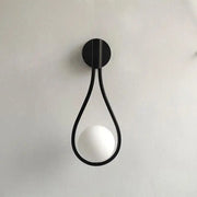 DecorBites™ modern Nordic black wall lamp featuring a minimalist teardrop frame with a frosted spherical bulb
