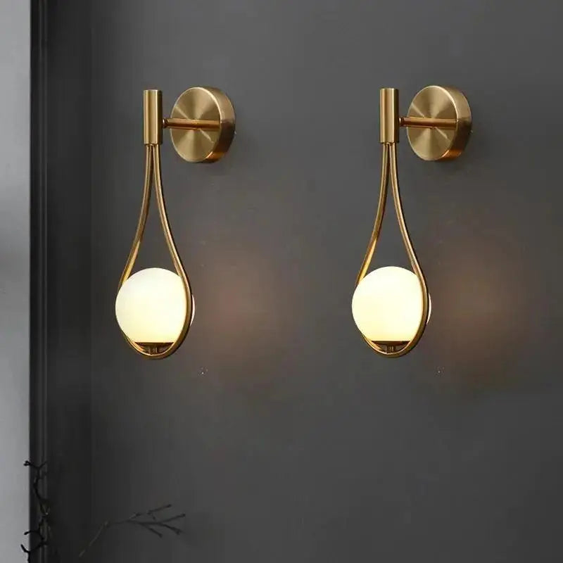 DecorBites™ modern Nordic wall lamp featuring gold-toned teardrop metal frames and warm-glowing spherical glass shades