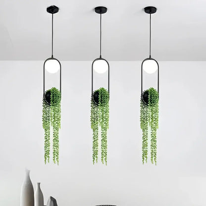 DecorBites™ modern planter pendant lighting with three black pendant lights featuring white bulbs and green vines