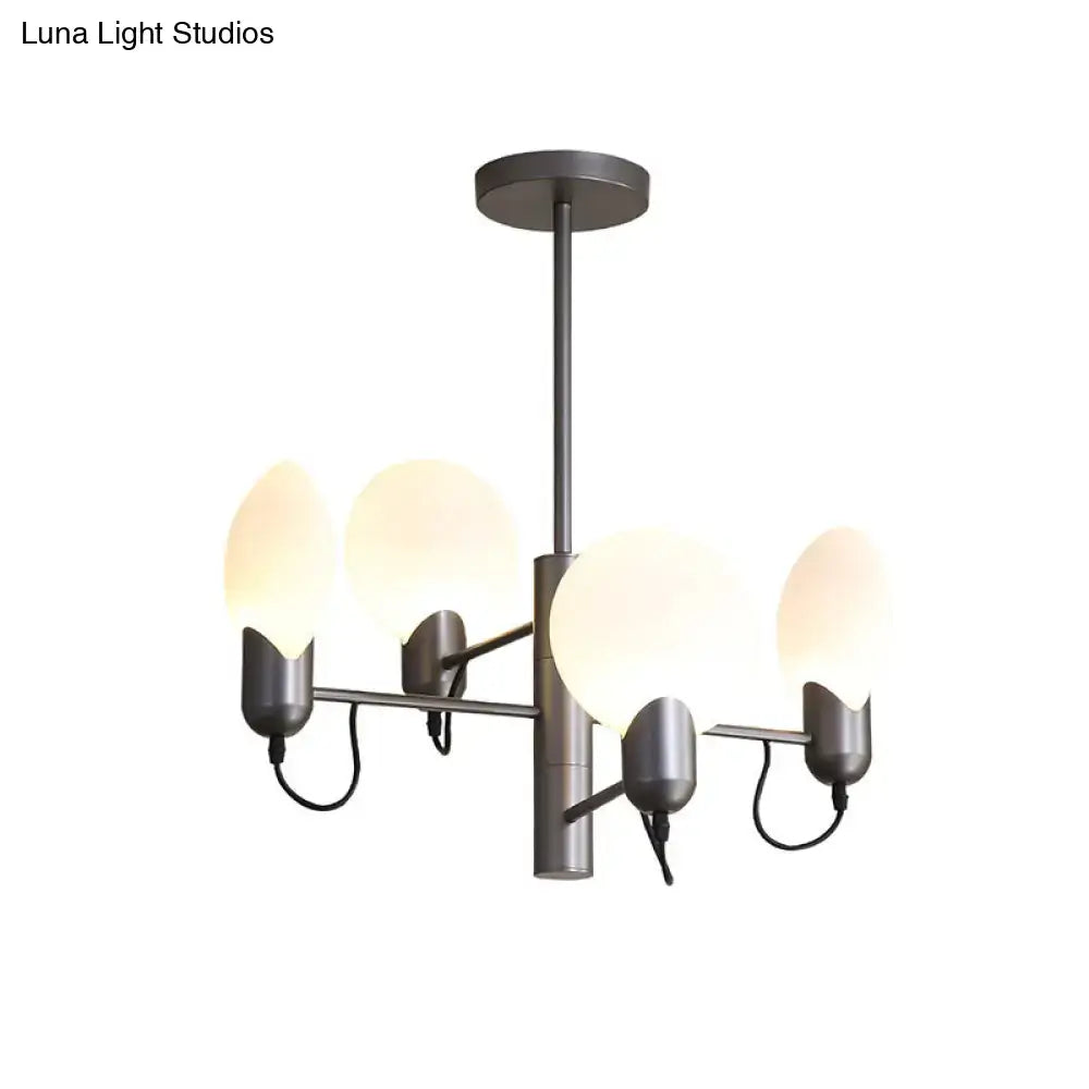 Modern matte black metal chandelier with four frosted globe shades complements silver gray opal glass ceiling light