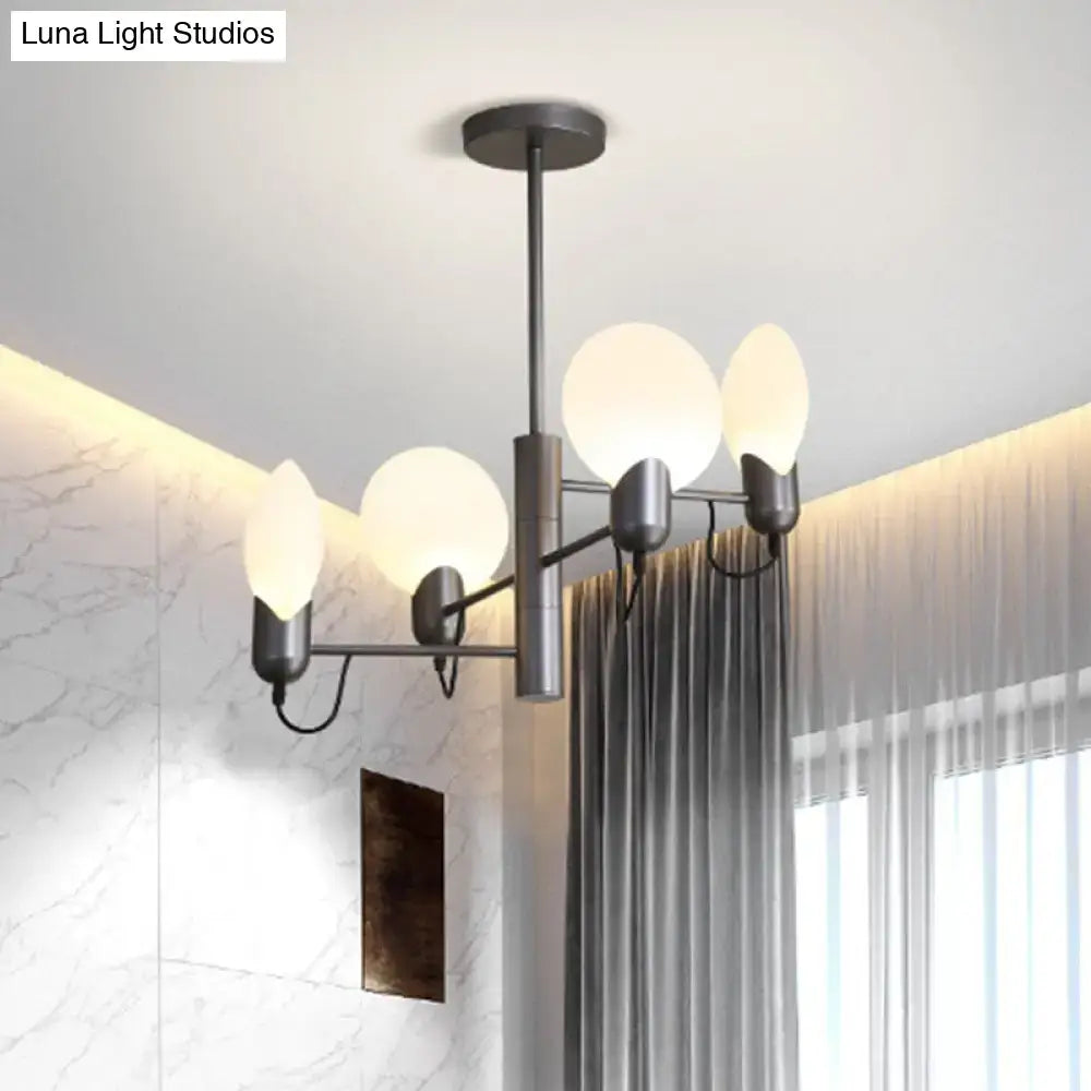 Modern black metal chandelier with five frosted opal glass globe shades complementing silver gray ceiling light design