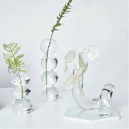Clear glass vases set with spherical and curved designs featuring delicate greenery for decorate root width 750px height display