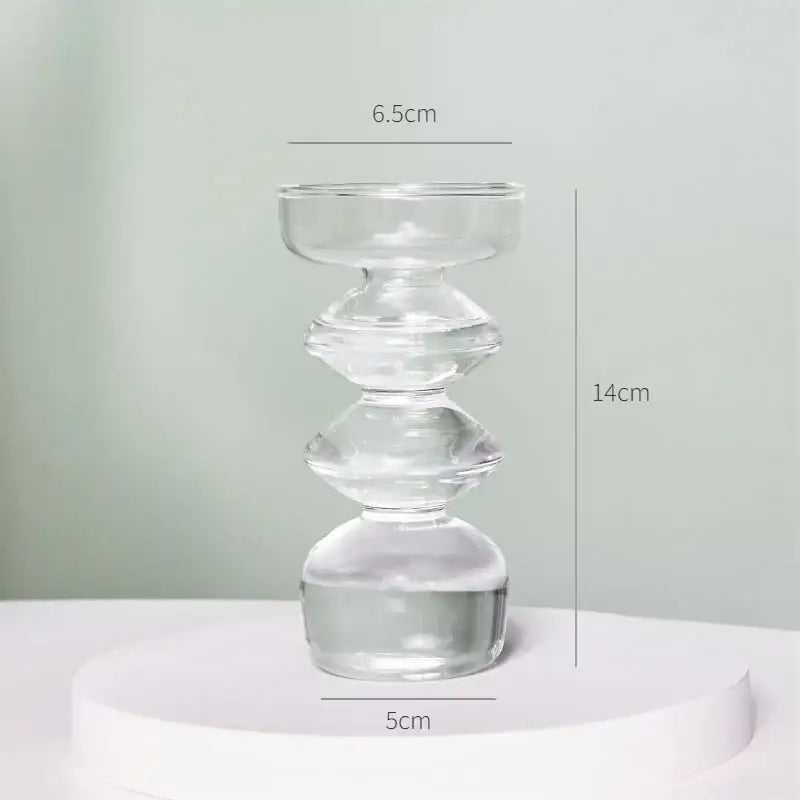 Clear glass candle holder with stacked rounded tiers and smooth transparent finish in decorbites modern vase set