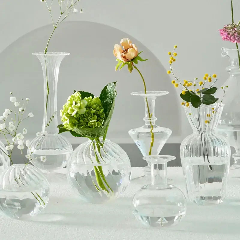 DecorBites modern transparent glass vases set with ribbed textures holding delicate flowers to decorate root spaces