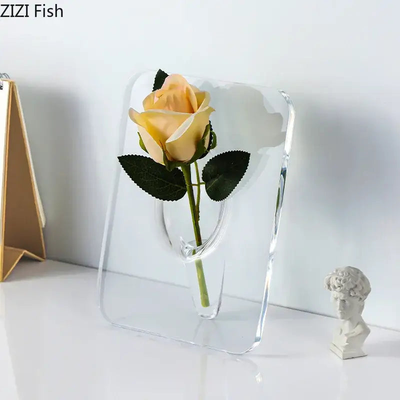DecorBites modern transparent square vase made of clear acrylic with a curved cutout holding a pale yellow rose