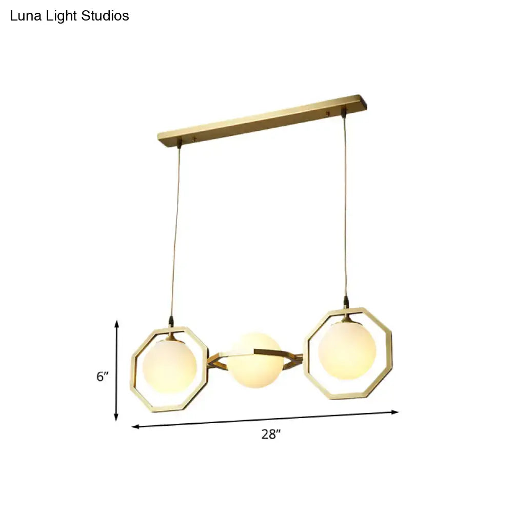 Modern pendant light with three white frosted glass orb shades in a gold octagon frame for ceiling installation