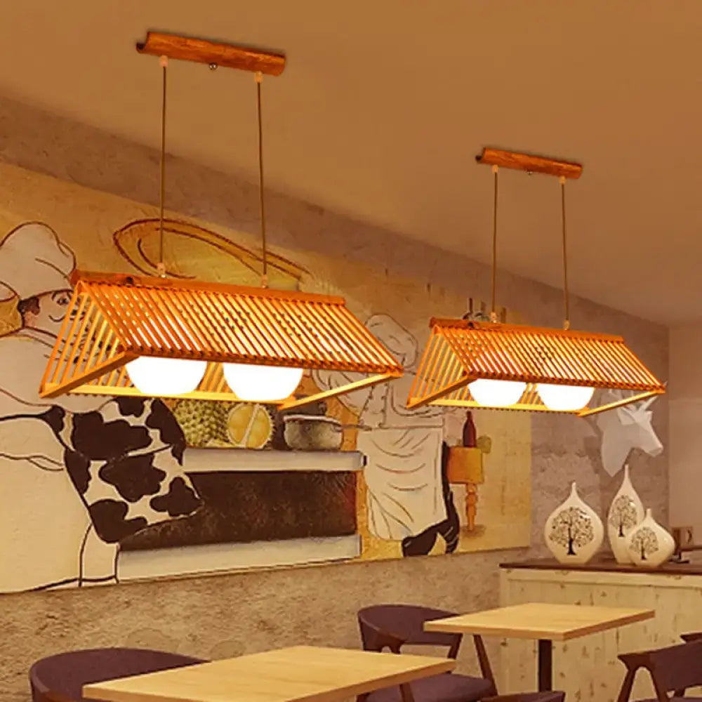 Two warm-toned rectangular pendant ceiling lights with woven bamboo shades and cream glass shade fixtures hanging by chain cord length