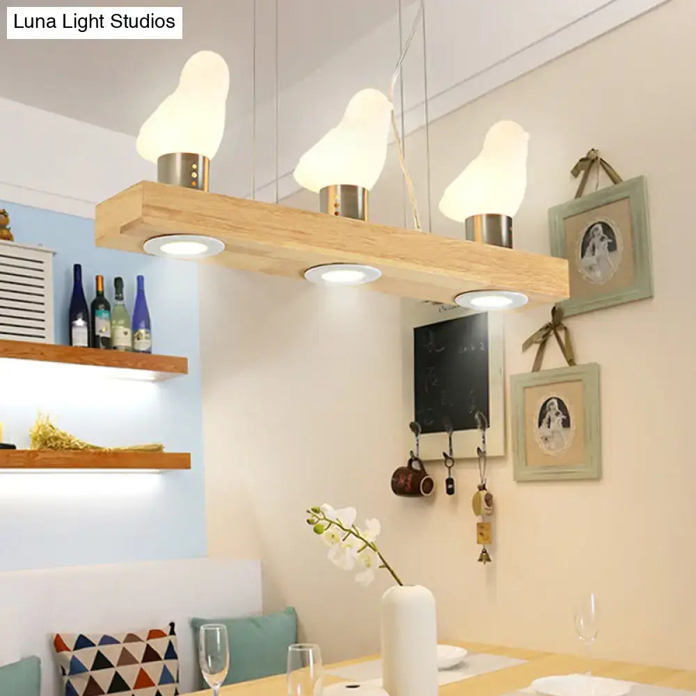 Decorbites modern wood island light with three white frosted glass bird-shaped shades for dining room pendant lighting