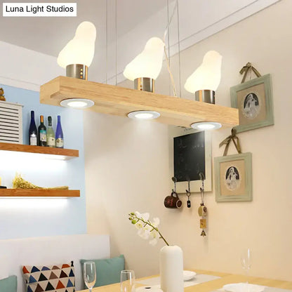 Decorbites modern wood island light with three white frosted glass bird-shaped shades for dining room pendant lighting