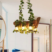 Rustic wooden pendant light with hanging green ivy and four warm glass lanterns in industrial style e26 e27 design
