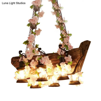 Rustic wooden pendant light with pink artificial flowers and hanging lanterns in industrial style e26 e27 design