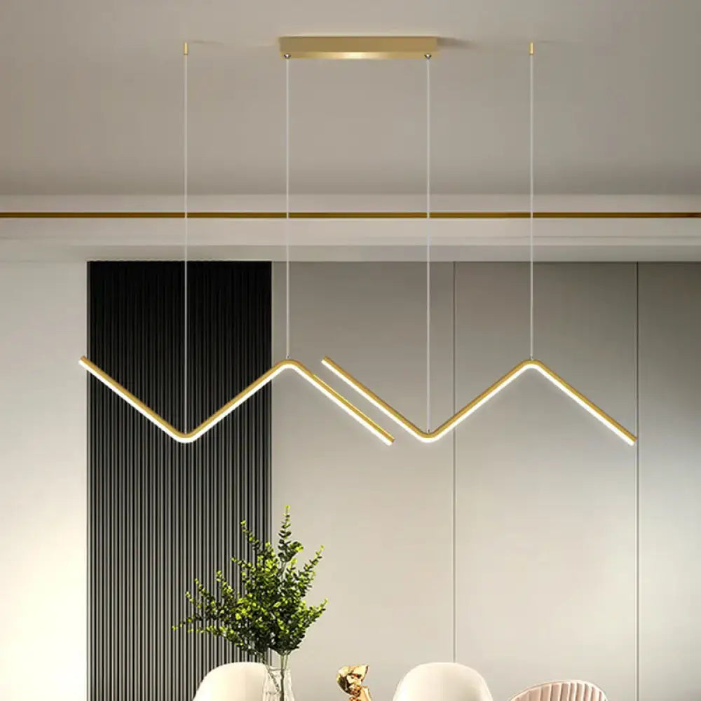 Modern gold-toned metal hanging lamp with sleek zigzag design and minimalist rectangular ceiling mount for dining room