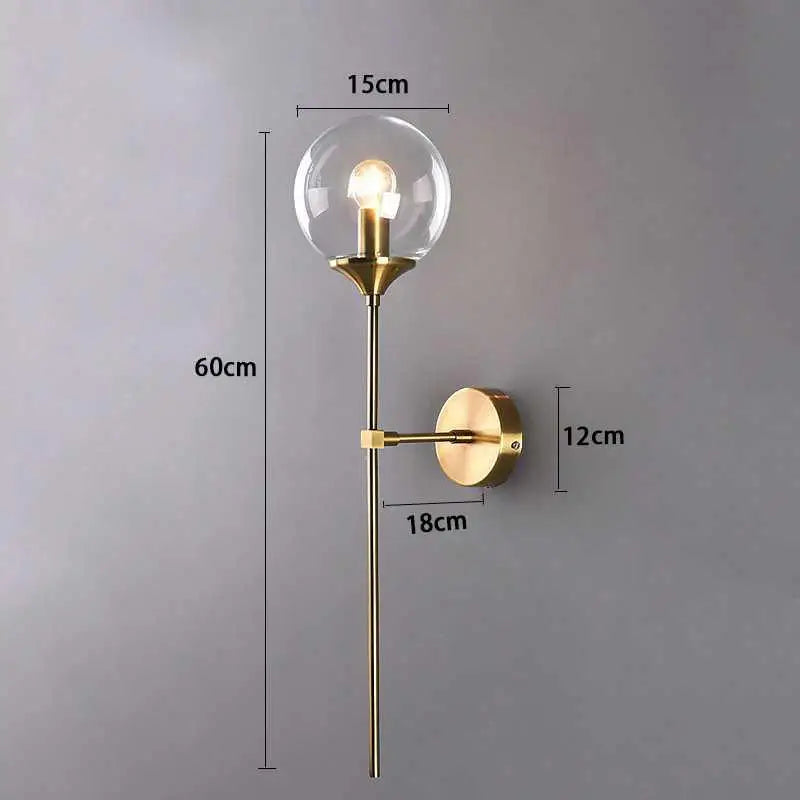 Gold-toned DecorBites™ Moroccan glass wall sconce with a clear glass globe and exposed bulb for stylish lighting