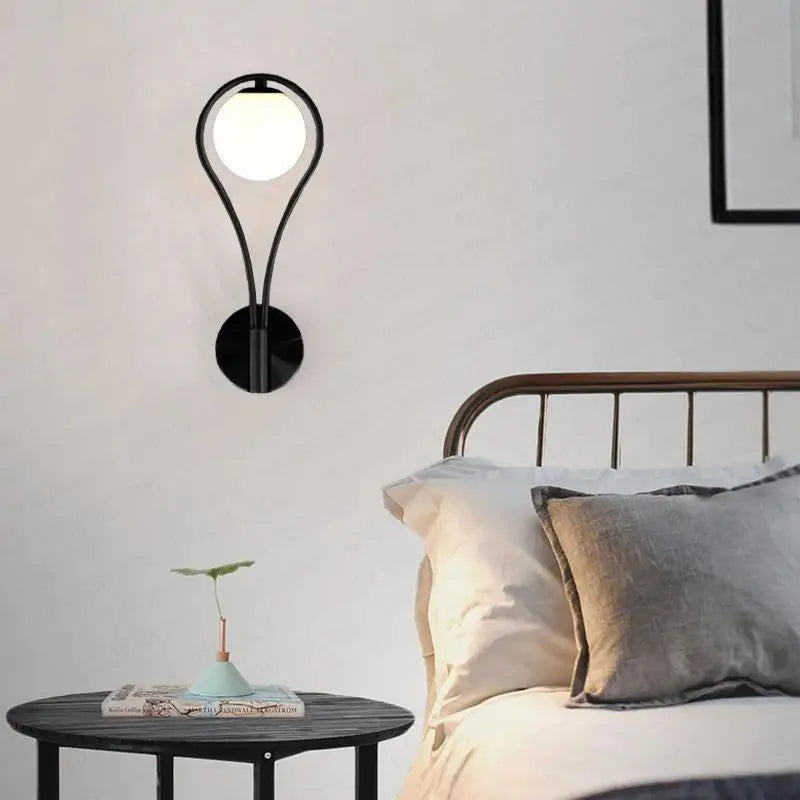 Black metal wall lamp with a teardrop frosted glass globe for modern nordic wall and nordic wall lamp decor