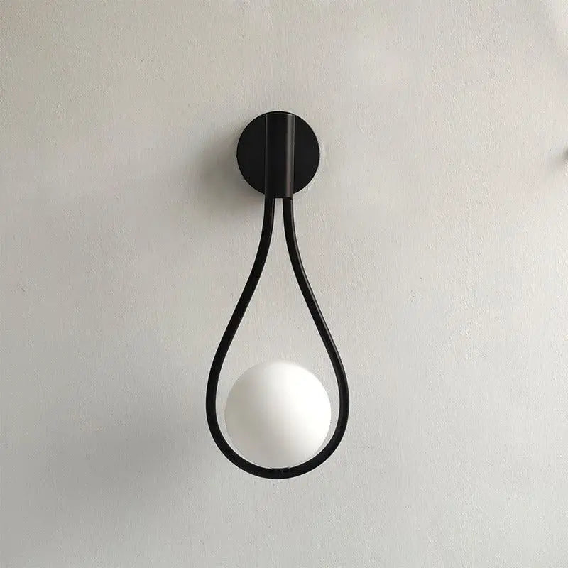 Black metal wall lamp with teardrop frame and white spherical bulb from DecorBites modern nordic wall lamp collection
