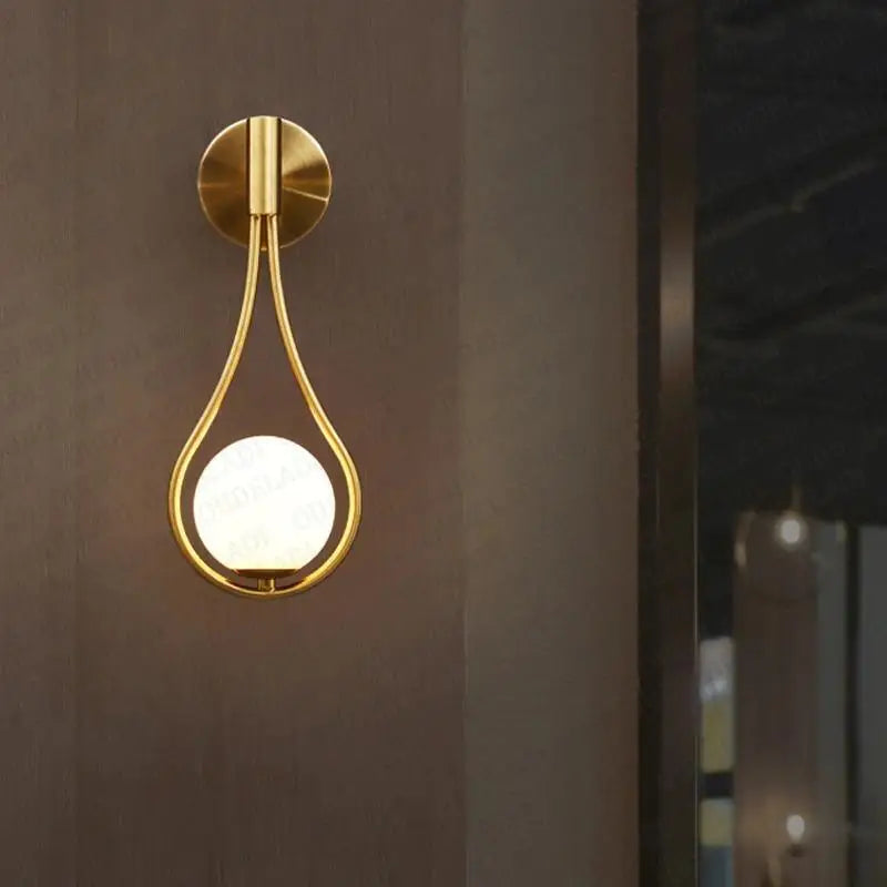 Gold-toned DecorBites™ Moroccan modern nordic wall lamp with teardrop shape and frosted glass globe wall lamp