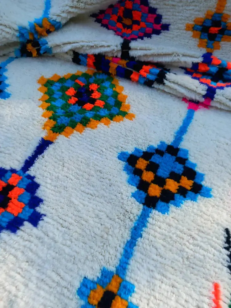 Plush white moroccan handmade azilal rug with vibrant blue orange green and black geometric patterns 2.5m x 1.5m
